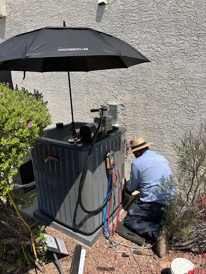 HVAC technician performing outdoor AC maintenance in Everett